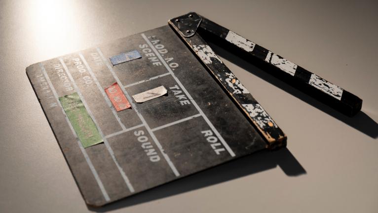 A black film clapper on a white table.